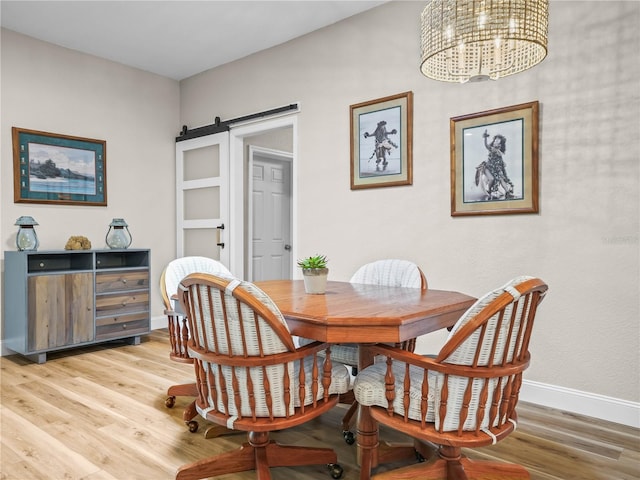 3802 Litchfield Loop, Lake Wales, FL 33859 - dining room with a chandelier, light wood-type flooring, and a barn door