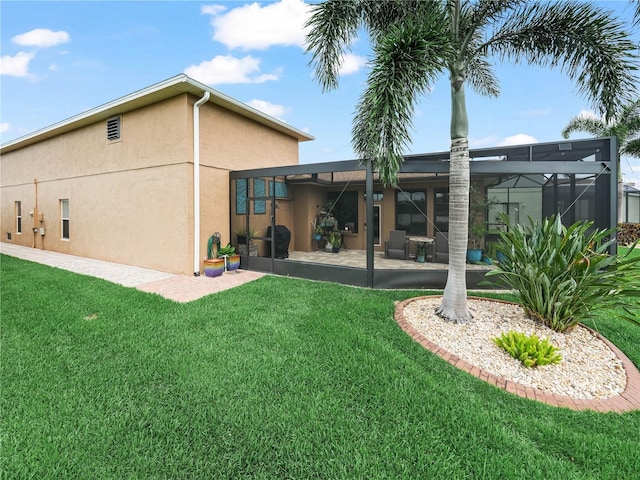 3802 Litchfield Loop, Lake Wales, FL 33859 - rear view of property with stucco siding, a patio area, a yard, and a lanai