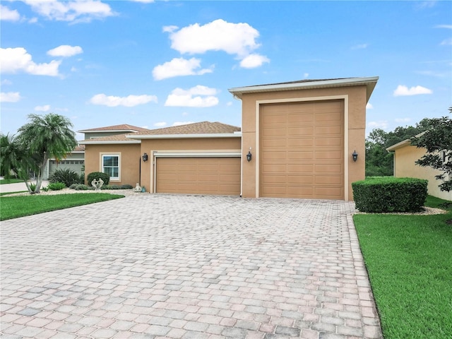 3802 Litchfield Loop, Lake Wales, FL 33859 - view of front of property featuring stucco siding, an attached garage, decorative driveway, and a front yard
