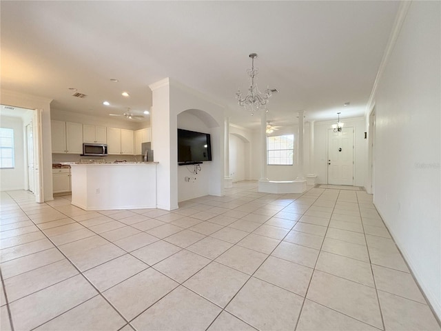 4469 Turnberry Ln, Lake Wales, FL 33859 - unfurnished living room with crown molding, light tile patterned floors, a chandelier, arched walkways, and recessed lighting
