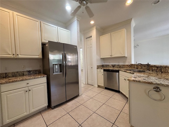 4469 Turnberry Ln, Lake Wales, FL 33859 - kitchen featuring appliances with stainless steel finishes, a ceiling fan, crown molding, light tile patterned floors, and white cabinets