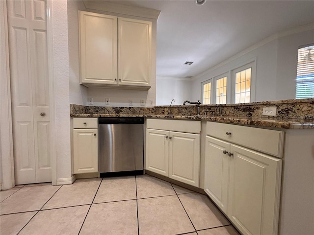 4469 Turnberry Ln, Lake Wales, FL 33859 - kitchen with stainless steel dishwasher, crown molding, white cabinetry, dark stone counters, and light tile patterned floors