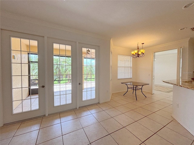 4469 Turnberry Ln, Lake Wales, FL 33859 - doorway to outside featuring ornamental molding, a chandelier, light tile patterned flooring, and french doors