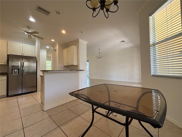 4469 Turnberry Ln, Lake Wales, FL 33859 - kitchen with refrigerator with ice dispenser, a chandelier, white cabinets, a ceiling fan, and dark stone countertops
