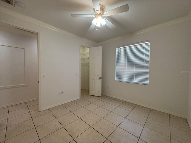 4469 Turnberry Ln, Lake Wales, FL 33859 - unfurnished bedroom with light tile patterned floors, crown molding, ceiling fan, a closet, and a spacious closet