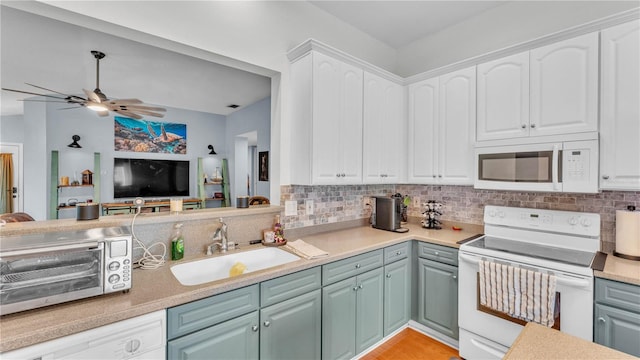 2602 Whitewood Rd, Mulberry, FL 33860 - kitchen featuring white appliances, backsplash, white cabinetry, and ceiling fan