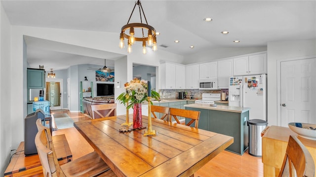 2602 Whitewood Rd, Mulberry, FL 33860 - dining area featuring lofted ceiling, a chandelier, a ceiling fan, light wood-type flooring, and recessed lighting