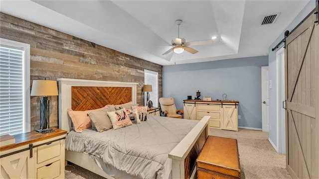 2602 Whitewood Rd, Mulberry, FL 33860 - bedroom with a barn door, light carpet, a raised ceiling, and ceiling fan