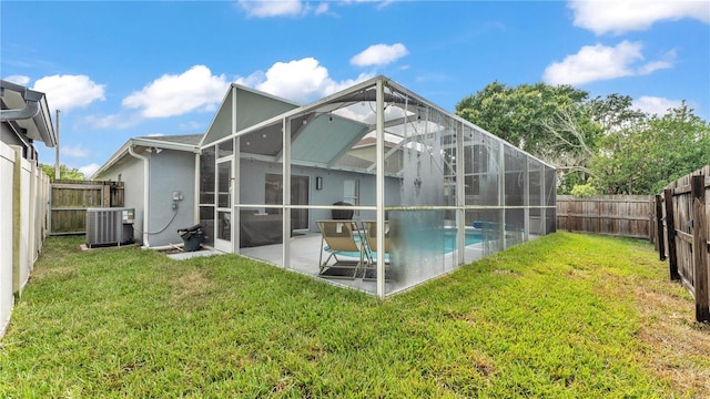 2602 Whitewood Rd, Mulberry, FL 33860 - back of house with a fenced backyard, a patio area, stucco siding, and glass enclosure