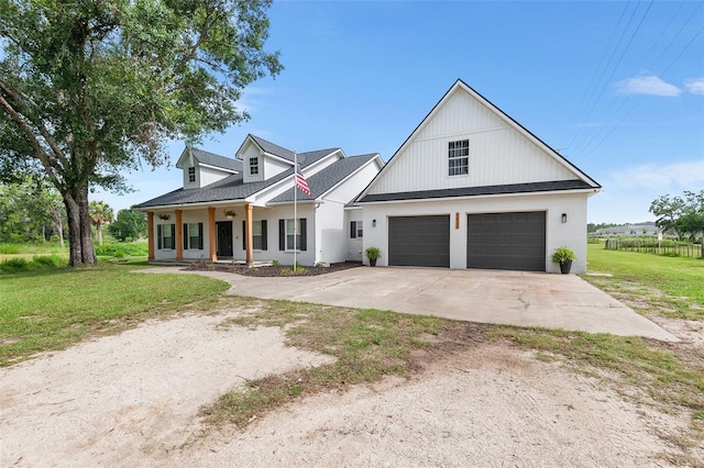 5820 E Johnson Ave, Haines City, FL 33844 - modern farmhouse with covered porch, a front yard, concrete driveway, and stucco siding