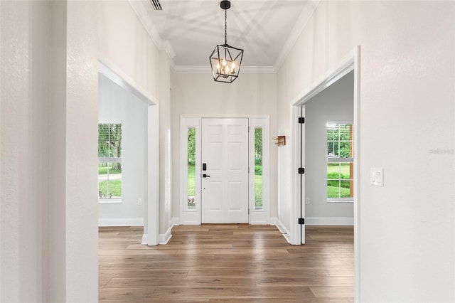 5820 E Johnson Ave, Haines City, FL 33844 - foyer with a chandelier, hardwood / wood-style flooring, and crown molding
