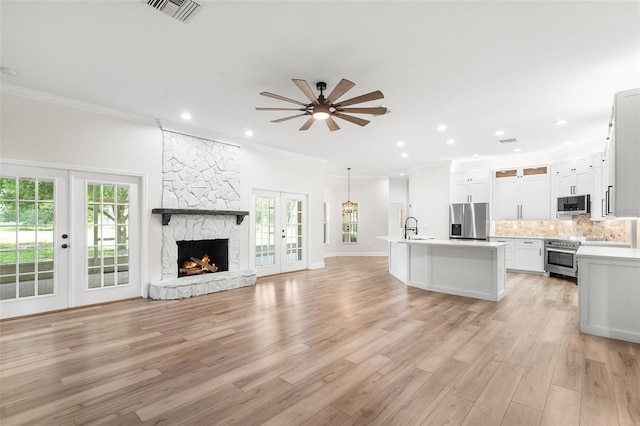 5820 E Johnson Ave, Haines City, FL 33844 - unfurnished living room with french doors, ornamental molding, healthy amount of natural light, light wood-style floors, and recessed lighting