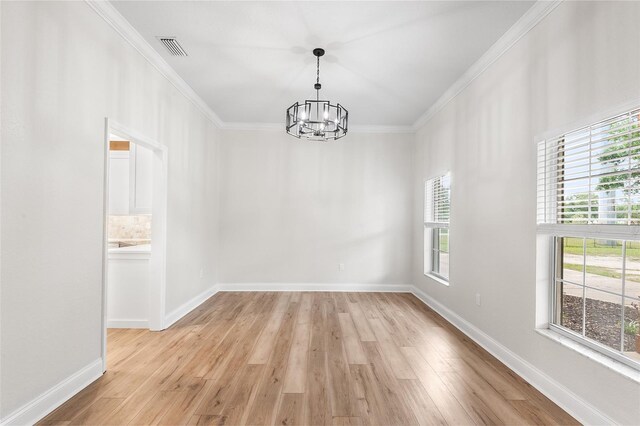 5820 E Johnson Ave, Haines City, FL 33844 - spare room with a chandelier, healthy amount of natural light, ornamental molding, and light wood-type flooring