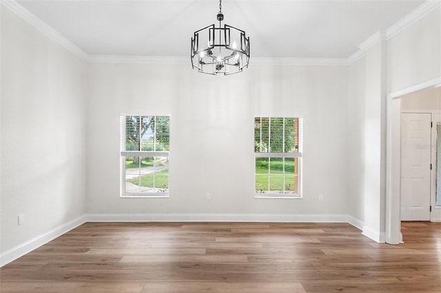 5820 E Johnson Ave, Haines City, FL 33844 - unfurnished room featuring a chandelier, plenty of natural light, ornamental molding, and wood finished floors