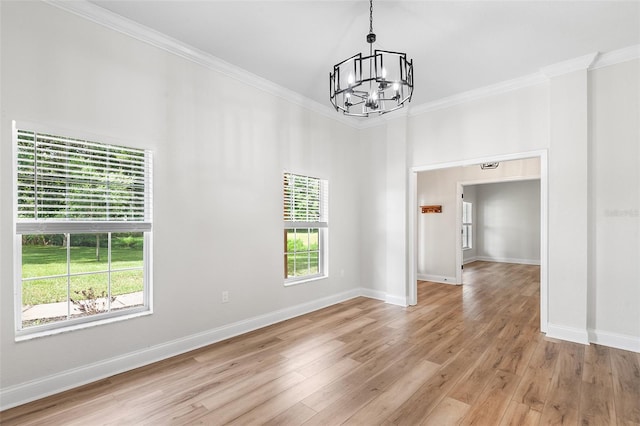 5820 E Johnson Ave, Haines City, FL 33844 - unfurnished room with a chandelier, ornamental molding, plenty of natural light, and light wood finished floors