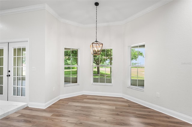5820 E Johnson Ave, Haines City, FL 33844 - unfurnished dining area featuring a chandelier, wood finished floors, crown molding, and french doors