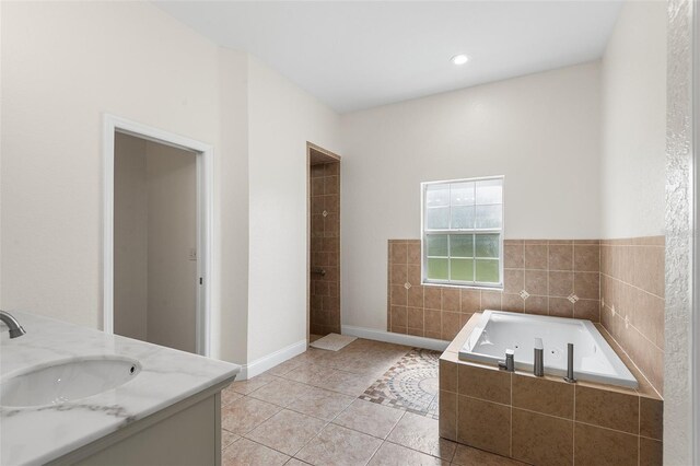 5820 E Johnson Ave, Haines City, FL 33844 - bathroom featuring a jetted tub, vanity, and tile patterned floors
