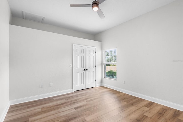 5820 E Johnson Ave, Haines City, FL 33844 - unfurnished bedroom featuring light wood-style floors, attic access, a closet, and a ceiling fan