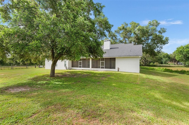 5820 E Johnson Ave, Haines City, FL 33844 - back of property featuring a sunroom, a chimney, and stucco siding