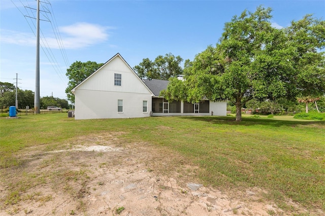5820 E Johnson Ave, Haines City, FL 33844 - back of house featuring a sunroom and a lawn
