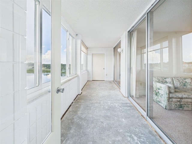 700 Mirror Ter NW Unit 702, Winter Haven, FL 33881 - unfurnished sunroom with a textured ceiling