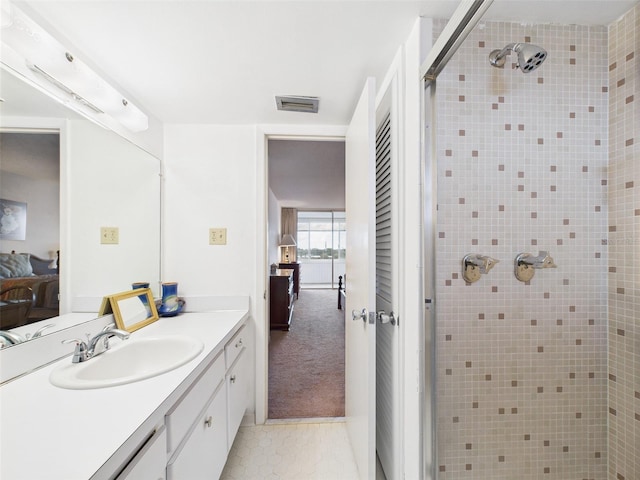 700 Mirror Ter NW Unit 702, Winter Haven, FL 33881 - bathroom featuring connected bathroom, a shower stall, vanity, and tile patterned floors
