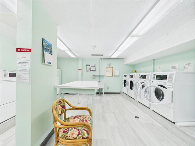700 Mirror Ter NW Unit 702, Winter Haven, FL 33881 - shared laundry room featuring separate washer and dryer and light wood-type flooring