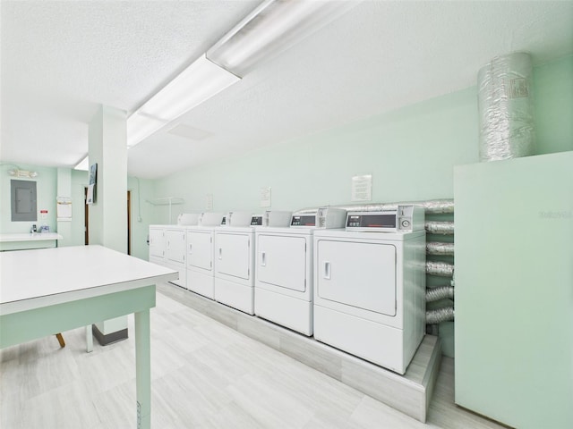 700 Mirror Ter NW Unit 702, Winter Haven, FL 33881 - community laundry with washing machine and clothes dryer and a textured ceiling