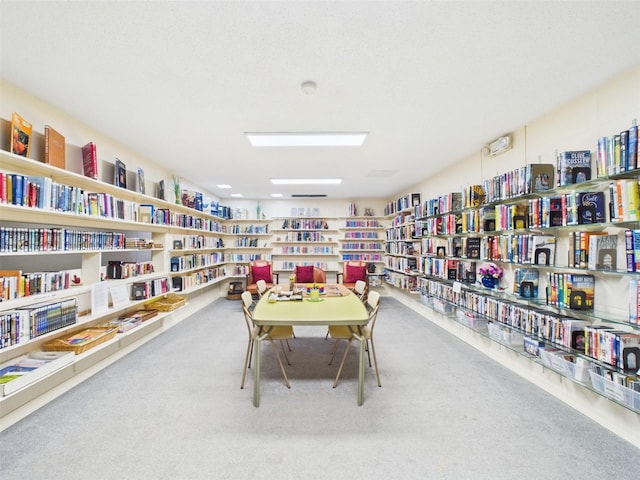 700 Mirror Ter NW Unit 702, Winter Haven, FL 33881 - interior space featuring wall of books and carpet floors