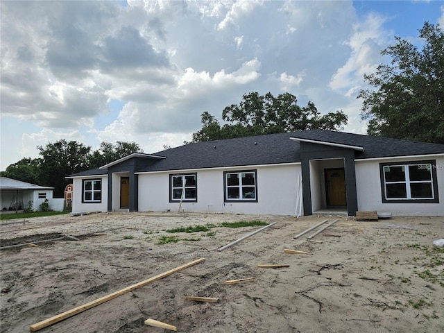 602 Lime Ave, Dundee, FL 33838 - view of front of house with stucco siding, uncovered parking, and a shingled roof