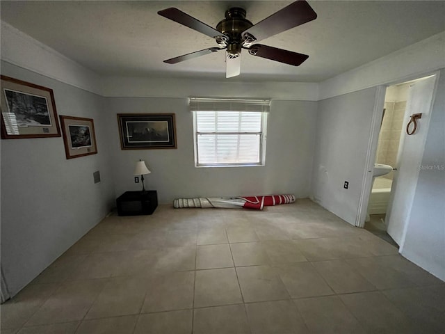 1805 S Lake Reedy Blvd, Frostproof, FL 33843 - unfurnished bedroom with tile patterned flooring, connected bathroom, and a ceiling fan