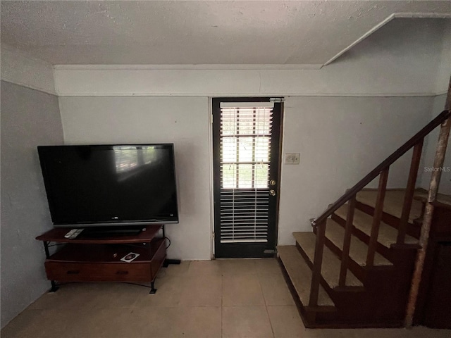 1805 S Lake Reedy Blvd, Frostproof, FL 33843 - tiled living room featuring stairs and a textured ceiling
