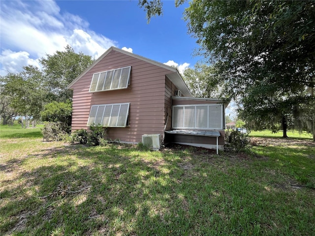 1805 S Lake Reedy Blvd, Frostproof, FL 33843 - back of house with a sunroom and a lawn