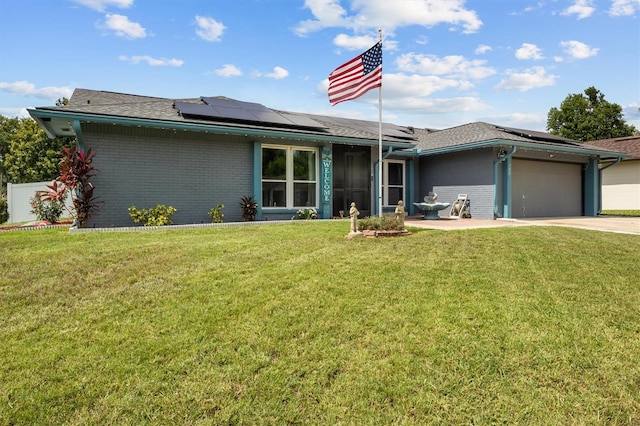 704 Butternut Pl, Lakeland, FL 33813 - view of front facade with brick siding, concrete driveway, a garage, and solar panels