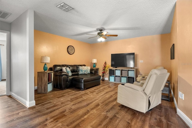 704 Butternut Pl, Lakeland, FL 33813 - living room featuring a ceiling fan, wood finished floors, and a textured ceiling