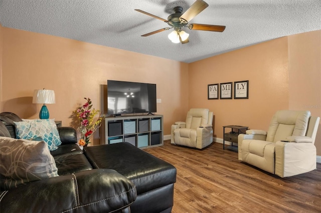 704 Butternut Pl, Lakeland, FL 33813 - living room with ceiling fan, wood finished floors, and a textured ceiling