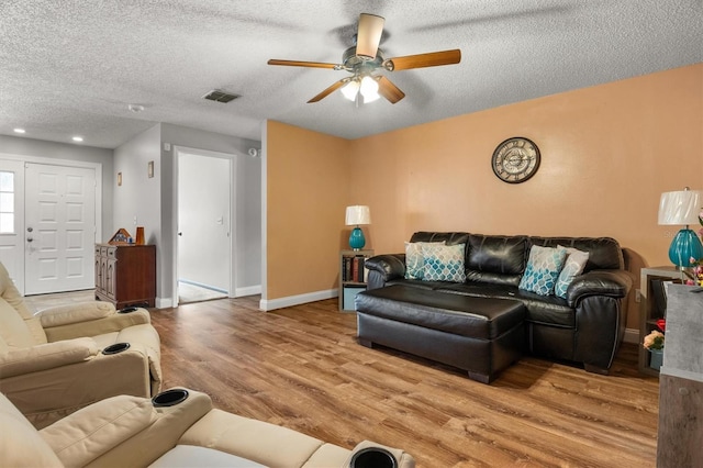 704 Butternut Pl, Lakeland, FL 33813 - living area with light wood finished floors, a ceiling fan, a textured ceiling, and recessed lighting