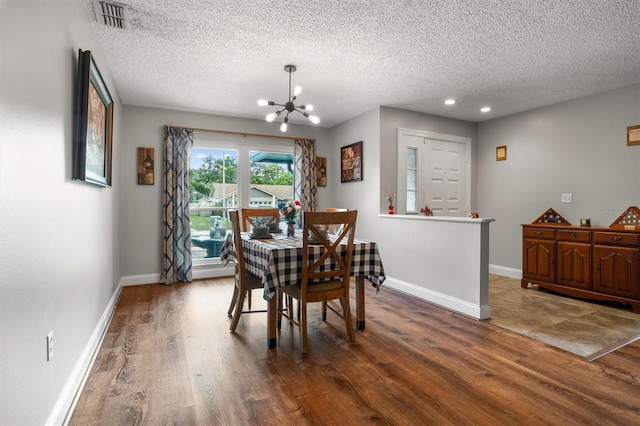 704 Butternut Pl, Lakeland, FL 33813 - dining area with a chandelier, wood finished floors, a textured ceiling, and recessed lighting