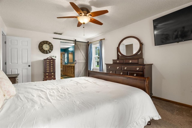 704 Butternut Pl, Lakeland, FL 33813 - carpeted bedroom featuring a barn door, a textured ceiling, and a ceiling fan