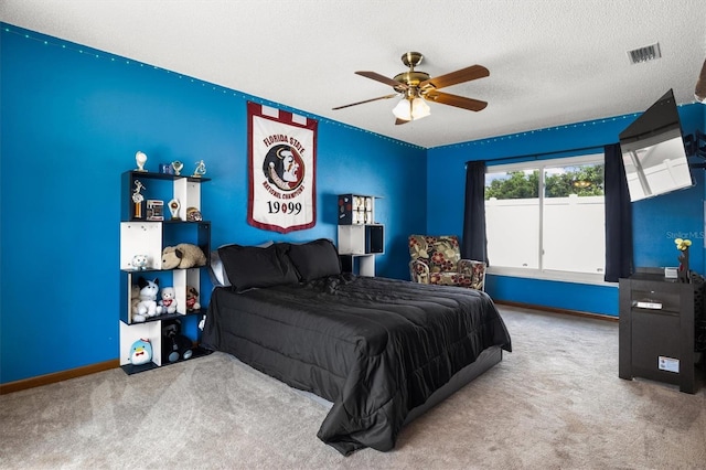 704 Butternut Pl, Lakeland, FL 33813 - bedroom with carpet flooring, a textured ceiling, and a ceiling fan