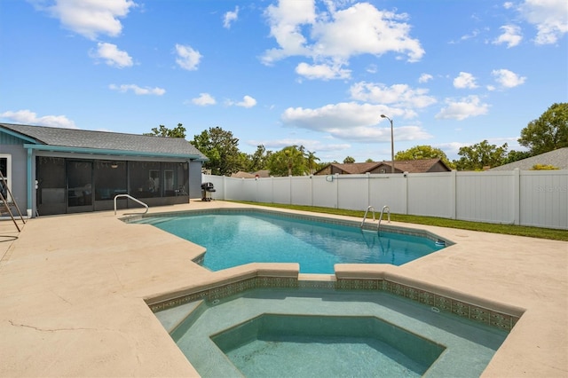 704 Butternut Pl, Lakeland, FL 33813 - view of pool with a sunroom, a patio, a fenced backyard, and a pool with connected hot tub