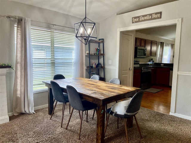 1790 Turtle Rock Dr, Lakeland, FL 33803 - carpeted dining area featuring a chandelier and baseboards