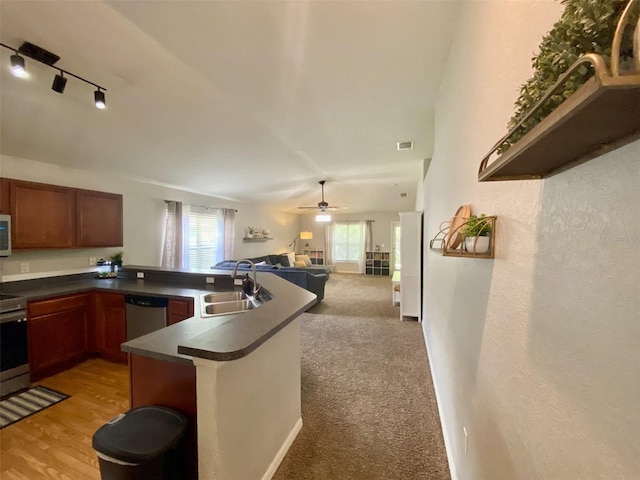 1790 Turtle Rock Dr, Lakeland, FL 33803 - kitchen featuring dishwasher, dark countertops, open floor plan, white microwave, and rail lighting
