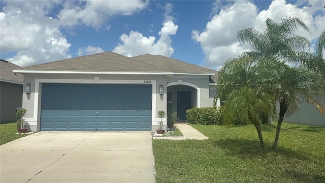 13443 Graham Yarden Dr, Riverview, FL 33579 - ranch-style home with stucco siding, concrete driveway, a front lawn, and a garage