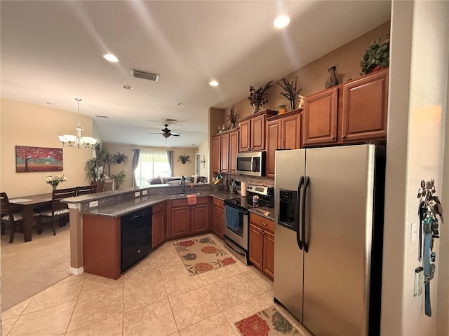 13443 Graham Yarden Dr, Riverview, FL 33579 - kitchen featuring stainless steel appliances, a peninsula, brown cabinetry, recessed lighting, and hanging light fixtures