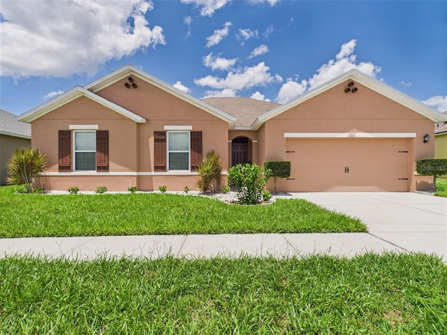 5751 Lakeside Landings Blvd, Winter Haven, FL 33881 - ranch-style house with stucco siding, driveway, a garage, and a front lawn