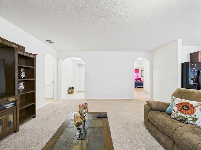 5751 Lakeside Landings Blvd, Winter Haven, FL 33881 - carpeted living room featuring arched walkways and a textured ceiling