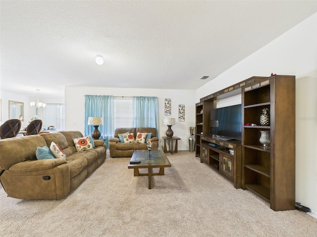 5751 Lakeside Landings Blvd, Winter Haven, FL 33881 - living room featuring light colored carpet, a chandelier, and a textured ceiling