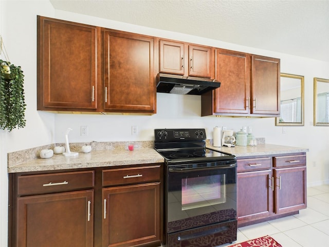 5751 Lakeside Landings Blvd, Winter Haven, FL 33881 - kitchen featuring black electric range oven, under cabinet range hood, light countertops, and light tile patterned flooring