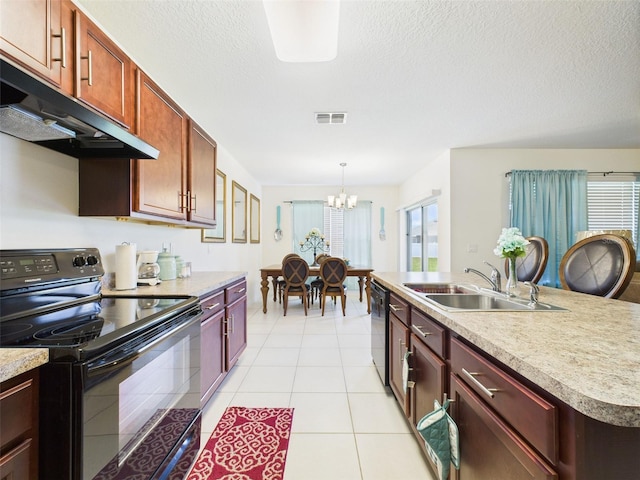 5751 Lakeside Landings Blvd, Winter Haven, FL 33881 - kitchen featuring black appliances, range hood, plenty of natural light, a chandelier, and a textured ceiling
